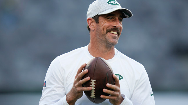 FILE - New York Jets quarterback Aaron Rodgers walks on the field during warm-ups before an NFL football game against the Tampa Bay Buccaneers, Saturday, Aug. 19, 2023, in East Rutherford, N.J. Heâll become a folk hero if he can lead the Jets to a Super Bowl for the first time since Broadway Joe Namath.(AP Photo/Seth Wenig, File)