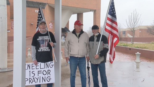 Three counter protesters stand outside of Freedom Hall (WCYB Photo).