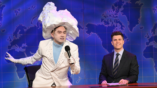 This image released by NBC shows Bowen Yang as the Iceberg that sank the Titanic, left, and anchor Colin Jost during Weekend Update on "Saturday Night Live" in New York on April 10, 2021. (Will Heath/NBC via AP)