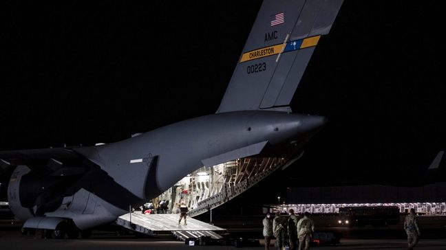 Airmen unload medical equipment after transporting COVID-19 patients during the first-ever operational use of the Transport Isolation System at Ramstein Air Base, Germany on April 10, 2020. (Photo:{ }Air Force Staff Sgt. Devin Nothstine)
