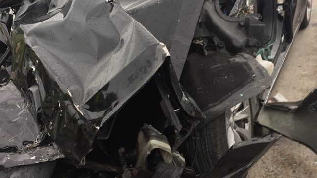 FILE - In this Friday, May 11, 2018, file photo released by the South Jordan Police Department shows a traffic collision involving a Tesla Model S sedan with a Fire Department mechanic truck stopped at a red light in South Jordan, Utah. The driver of a Tesla electric car that hit a Utah fire department vehicle over the weekend says the car's semi-autonomous Autopilot mode was engaged at the time of the crash. Police in the Salt Lake City suburb of South Jordan said Monday, May 14, 2018, the driver also said in an interview that she was looking at her phone before the accident. The 28-year-old woman broke her foot when her car hit a fire truck stopped at a red light while going 60 mph (97 kph). (South Jordan Police Department via AP, File )