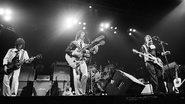 FILE - Paul McCartney and Wings perform before a sold-out audience of 14,000 at Tarrant County Convention Center in Fort Worth, Texas, May 4, 1976. Denny Laine, center, a British singer, songwriter and guitarist who performed in an early, pop-oriented version of the Moody Blues and was later McCartneyâs longtime sideman in the ex-Beatleâs solo band Wings, died Tuesday, Dec. 5, 2023, his wife said in a social media post. (AP Photo/File)