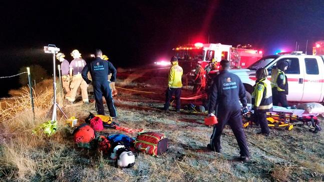 In this Wednesday, Sept. 18, 2019 photo provided by the California Department of Forestry and Fire Protection (Cal Fire) emergency personnel work as the scene of a tour bus crash, on Highway 46 near Shandon in California's Central Coast region. Authorities said the passenger bus crashed while carrying the road crew for country and gospel singer Josh Turner, leaving one dead and seven injured. Turner and his band were not on the bus.(Capt. Adan Orozco/Cal Fire via AP)