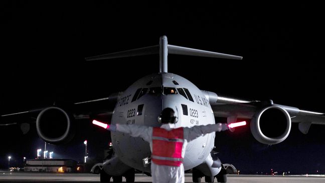 An airman at Ramstein Air Base, Germany, marshals a C-17 Globemaster III transporting three COVID-19 patients from Afghanistan on April 10, 2020. (Photo:{ }Air Force Staff Sgt. Devin Nothstine)