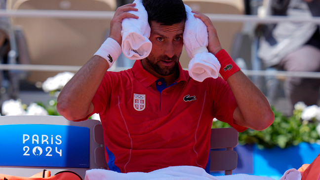 Serbia's Novak Djokovic cools off during a break as he plays Spain's Rafael Nadal during their men's singles second round match at the 2024 Summer Olympics, Monday, July 29, 2024, at the Roland Garros stadium in Paris, France. (AP Photo/Andy Wong)