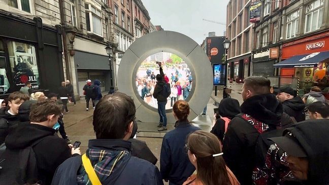 People view the live stream portal between Dublin and New York, in Dublin, Ireland, on Monday May 13, 2024. (Niall Carson/PA via AP)