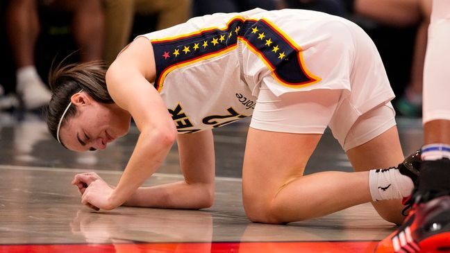 Indiana Fever guard Caitlin Clark (22) grimaces after being injured in the first half of a WNBA basketball game against the Connecticut Sun in Indianapolis, Monday, May 20, 2024. (AP Photo/Michael Conroy)