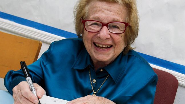 FILE - Dr. Ruth Westheimer signs a copy of her book "Sexually Speaking" in New York on April 26, 2012. (AP Photo/Richard Drew, File)