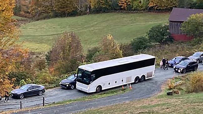 FILE - A tour bus shares a narrow road with cars outside a private property in an undated photo in Pomfret, Vt., that has become a destination for fall foliage viewers, clogging the rural road.{&nbsp;} (AP Photo)