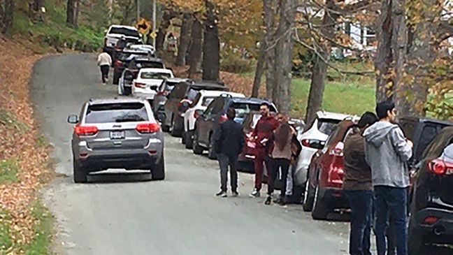 FILE - People and cars line a narrow road outside a private property in an undated photo, in Pomfret, Vt., that has become a destination for fall foliage viewers, clogging the rural road.{&nbsp;} (AP Photo)