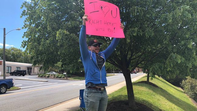 Although Daryl can't be inside the hospital due to restrictions, he's sitting outside of Pearson Cancer Center where his wife, Johanna, is getting chemo with a sign that says "I love you" (WSET)