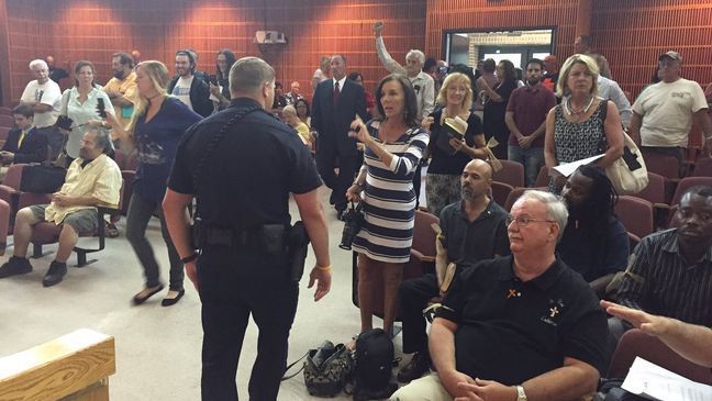 A satanic prayer was disrupted during a city council meeting in Pensacola, Fla. Thursday, July 14, 2016. (WEAR)