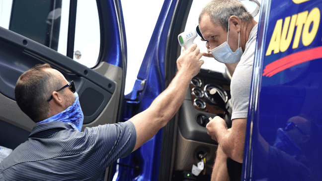 DARLINGTON, SOUTH CAROLINA - MAY 16: NASCAR personnel measures the temperature of a team hauler driver on entry to the track prior to the NASCAR Cup Series The Real Heroes 400 tomorrow at the Darlington Raceway, the first professional motorsport to resume the season after the nationwide lockdown due to the ongoing Coronavirus (COVID-19)  on May 16, 2020 in Darlington, South Carolina. (Photo by Jared C. Tilton/Getty Images)