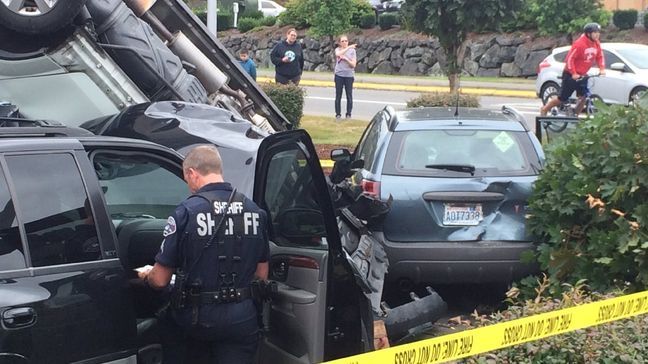 An SUV sits upside-down after crashing through a Starbucks drive-thru line in Puyallup on Aug. 9, 2016. (Photo: KOMO News).