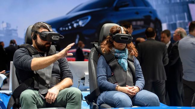 Journalists are testing virtual Hyundai test drives during the press day at the 87th Geneva International Motor Show in Geneva, Switzerland, Tuesday, March 7, 2017. The Motor Show will open its gates to the public from March 9 to 19. (Martial Trezzini/Keystone via AP)