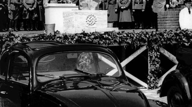 FILE - In this May 26, 1938 file photo, German Nazi leader Adolf Hitler speaks at the opening ceremony of the Volkswagen car factory in Fallersleben, Lower Saxony, Germany. Volkswagen is halting production of the last version of its Beetle model in July 2019 at its plant in Puebla, Mexico, the end of the road for a vehicle that has symbolized many things over a history spanning eight decades since 1938. (AP Photo, File)