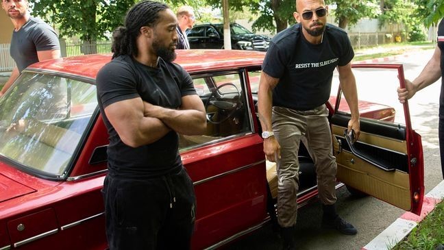 Andrew Tate and his brother Tristan, top left, arrives at a police station in a Lada vehicle in Voluntari, Romania, Wednesday, May 21, 2025. (AP Photo/Vadim Ghirda)