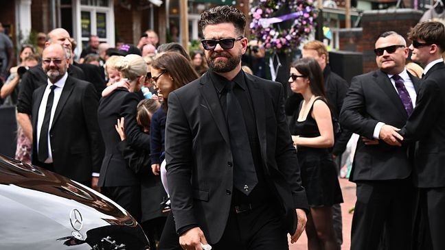 BIRMINGHAM, ENGLAND - JULY 30: Jack Osbourne arrives to view tributes to the late Ozzy Osbourne as the funeral cortege travels through his home city of Birmingham on July 30, 2025 in Birmingham, England. The Black Sabbath frontman passed away on July 22nd at the age of 76. His death occurred just a little over two weeks after his final live performance at the 'Back to the Beginning' concert in his hometown of Birmingham. (Photo by Leon Neal/Getty Images)