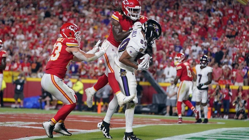 Baltimore Ravens tight end Isaiah Likely (80) catches a pass with his toe out of bounds as Kansas City Chiefs linebacker Nick Bolton  and linebacker Drue Tranquill, left, defend as time time expires in the second half of an NFL football game Thursday, Sept. 5, 2024, in Kansas City, Mo. The Chiefs won 27-20.(AP Photo/Ed Zurga)