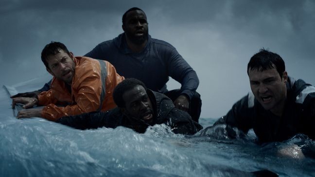 Zachary Levi as sole survivor Nick Schuyler holds on to capsized boat with{ }William Bleakley (Marshall Cook), Marquis Cooper (Quentin Plair), and Corey Smith (Terrence Terrell in"Not Without Hope." (Courtesy Inaugural Entertainment)