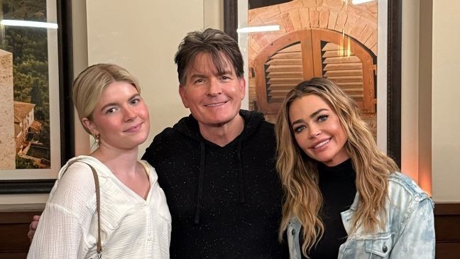 Lola allegedly “laughed” at her sister Sami when asked to attend a Pride parade with her and it “got really weird” when she asked how Lola would feel on her having a future same-sex marriage. (Pictured: Lola Sheen, dad Charlie Sheen, and mom Denise Richards; Credit: Instagram/Denise Richards)