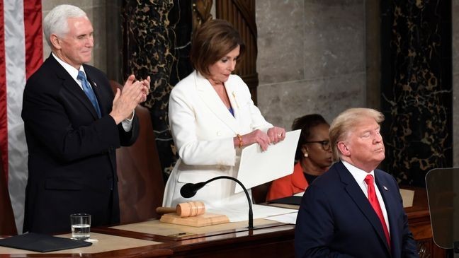 FILE - House Speaker Nancy Pelosi of Calif., tears her copy of President Donald Trump's s State of the Union address after he delivered it to a joint session of Congress on Capitol Hill in Washington, Feb. 4, 2020, as Vice President Mike Pence is at left. (AP Photo/Susan Walsh, File)
