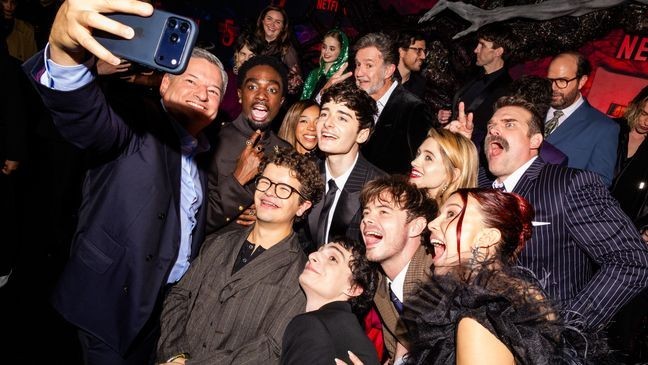 HOLLYWOOD, CALIFORNIA - NOVEMBER 06: (L-R) Cast and crew, such as Ted Sarandos, Co-CEO, Netflix, Caleb McLaughlin, Priah Ferguson, Joe Chrest, Dan Cohen, Gaten Matarazzo, Noah Schnapp, Natalia Dyer, Charlie Heaton, Finn Wolfhard, David Harbour, Brett Gelman, Millie Bobby Brown, and Jamie Campbell Bower attend Netflix's "Stranger Things" Season 5 World Premiere at TCL Chinese 6 Theatres on November 06, 2025, in Hollywood, California. (Photo by Roger Kisby/Getty Images for Netflix)