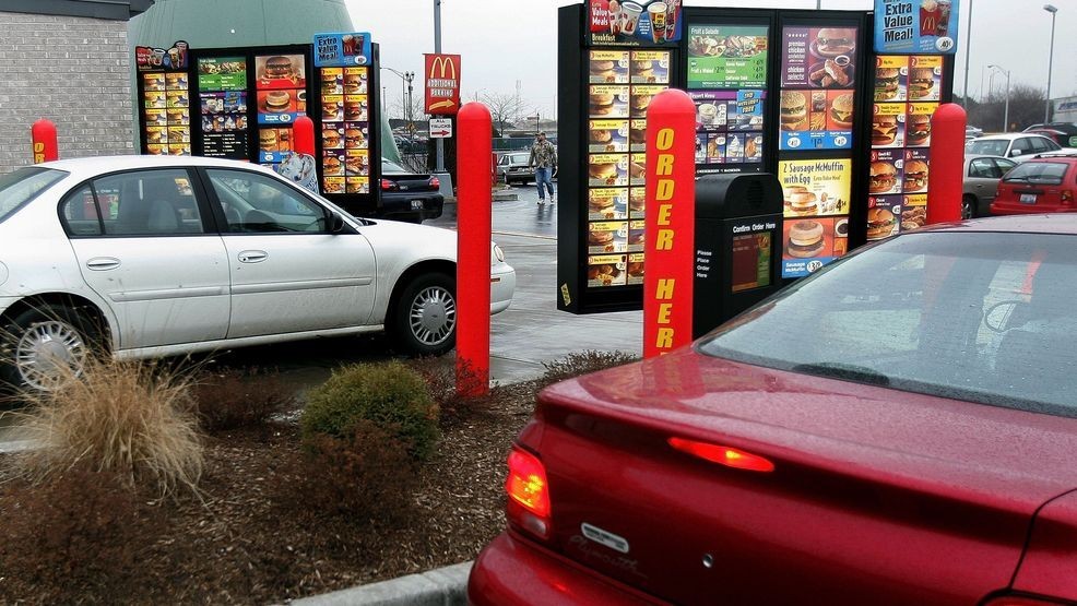 FILE - Vehicles in two separate drive-up lanes place orders at a McDonald's drive-thru location January 17, 2006, in Rosemont, Illinois. (Photo by Tim Boyle/Getty Images)