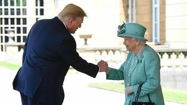 Britain's Queen Elizabeth II greets President Donald Trump as he arrives for a welcome ceremony in the garden of Buckingham Palace, in London, Monday, June 3, 2019, on the first day of a three day state visit to Britain. (Victoria Jones/Pool via AP)