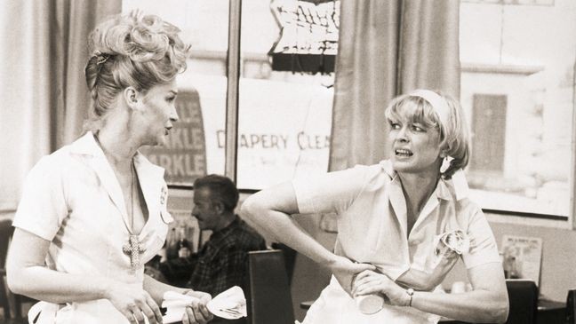(Original Caption) 9/1974- Actress Diane Ladd (left) and Ellen Burstyn in a scene from the movie Alice Doesn't Live Here Anymore. Burstyn is shown trying to open a jar as Ladd sets a table in a diner.