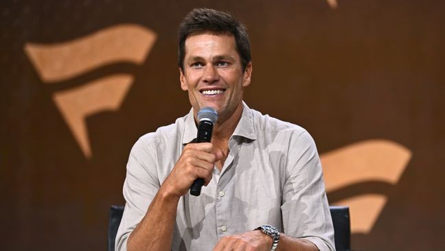 NEW YORK, NEW YORK - AUGUST 16: Tom Brady speaks at the Fanatics Fest NYC 2024 at Jacob Javits Center on August 16, 2024 in New York City.  (Photo by Roy Rochlin/Getty Images for Fanatics)