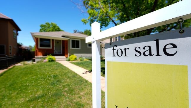 FILE - A for sale sign stands outside a single-family residence on the market Wednesday, May 22, 2024, in southeast Denver.  (AP Photo/David Zalubowski, File)