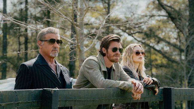 Sylvester Stallone as Dwight Manfredi, Garrett Hedlund as Mitch and Bella Heathcote as Cleo in the Paramount+ original series TULSA KING. Photo Credit: Brian Douglas/Paramount+. ©2025 Viacom International Inc. All Rights Reserved.