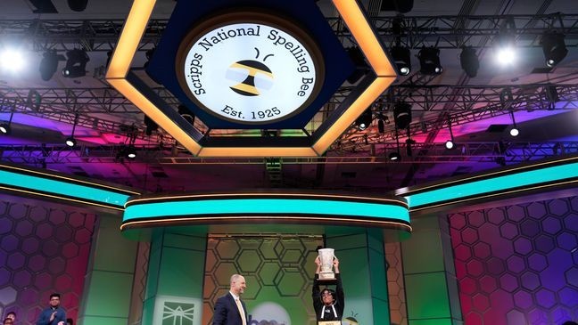 E.W. Scripps Company president and CEO Adam Symson presents the trophy to Faizan Zaki, 13, of Dallas, the winner of the 2025 Scripps National Spelling Bee, Thursday, May 29, 2025, in Oxon Hill, Md. (AP Photo/Julia Demaree Nikhinson)