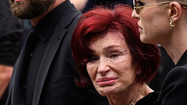 BIRMINGHAM, ENGLAND - JULY 30: (L-R) Jack Osbourne, Sharon Osbourne and Kelly Osbourne leave after viewing tributes to the late Ozzy Osbourne from fans as his funeral cortege travels through his home city of Birmingham on July 30, 2025 in Birmingham, England. The Black Sabbath frontman passed away on July 22nd at the age of 76. His death occurred just a little over two weeks after his final live performance at the 'Back to the Beginning' concert in his hometown of Birmingham. (Photo by Leon Neal/Getty Images)