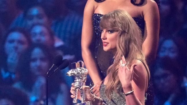 Taylor Swift accepts the video of the year award for "Fortnight" during the MTV Video Music Awards on Wednesday, Sept. 11, 2024, at UBS Arena in Elmont, N.Y. Megan Thee Stallion looks on from left. (Photo by Charles Sykes/Invision/AP)