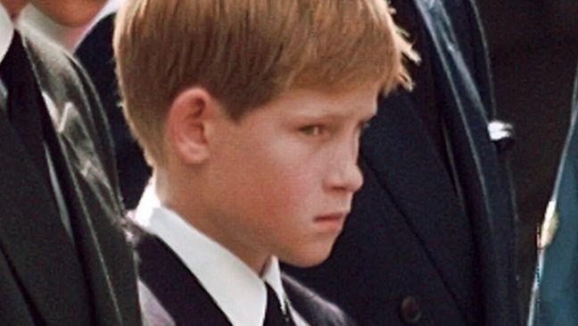 FILE - Britain's Prince Charles, the Prince of Wales, and his sons Prince William, left, and Prince Harry wait for the coffin of Princess Diana to be loaded into a hearse outside of Westminster Abbey, in London on Sept. 6, 1997.  (John Gaps III/Pool Photo via AP, File)