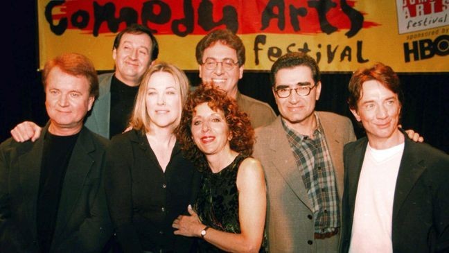 FILE - Former cast members of SCTV, from left, Dave Thomas, Joe Flaherty, Catherine O'Hara, Andrea Martin, foreground, Harold Ramis, Eugene Levy and Martin Short, pose at the U.S. Comedy Arts Festival on March 6, 1999, in Aspen, Colo. (AP Photo/E Pablo Kosmicki, File)