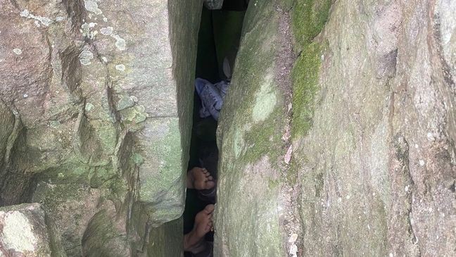 A woman slipped into a 10-foot-deep crevice and spent about seven hours stuck between massive rocks before she was rescued in Australia. (New South Wales Ambulance)