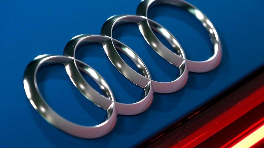 FILE - In this file photo dated Thursday, March 14, 2019, the logo of the German car manufacturer Audi is pictured on a Audi e-tron prior to the annual press conference in Ingolstadt, Germany. The Ingolstadt-based automaker said Tuesday Nov. 26, 2019, that it expected to add 2,000 new positions while Volkswagen subsidiary Audi says it is cutting 9,500 jobs in Germany through 2025. (AP Photo/Matthias Schrader, FILE)