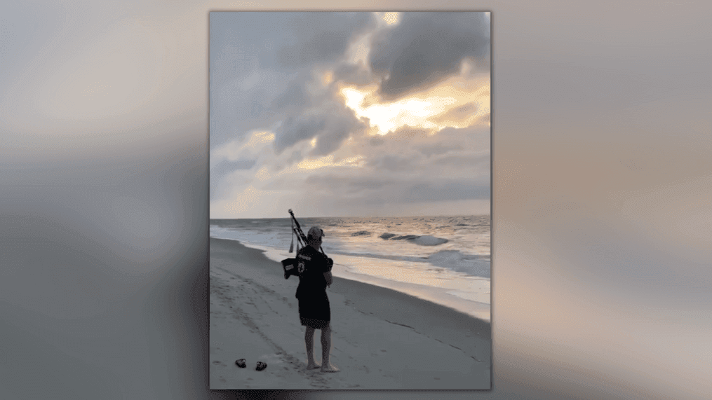 Musician plays Amazing Grace on bagpipes during Surfside Beach sunrise (Credit: Jane Calhoun)