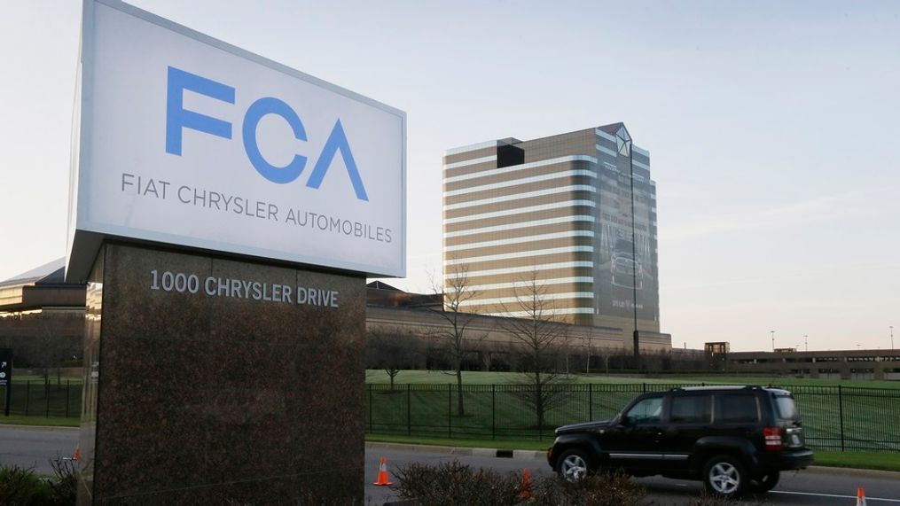 In this May 6, 2014, file photo, a vehicle moves past a sign outside Fiat Chrysler Automobiles world headquarters in Auburn Hills, Mich. Fiat Chrysler will pay more than $650 million to settle allegations that it cheated on emissions tests involving more than 104,000 Jeep SUVs and Ram pickup trucks, a person with the knowledge of the settlement told The Associated Press on Wednesday, Jan. 9, 2019. (AP Photo/Carlos Osorio, File)