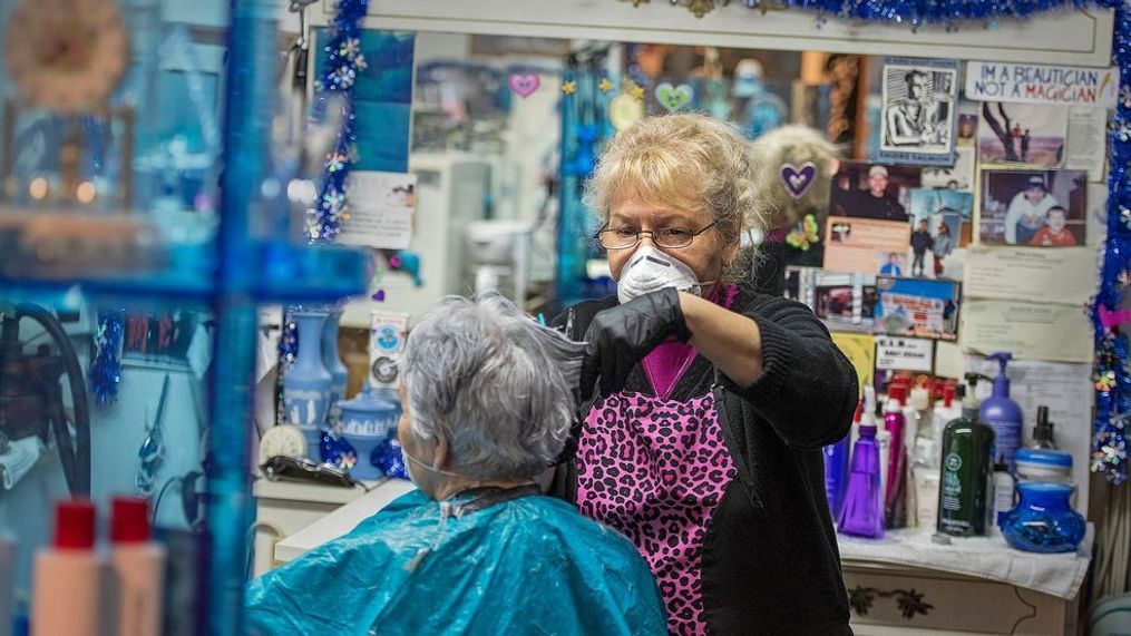 Dody's Hair Creation owner and operator Dody Morrison wears personal protective equipment during a haircut service for Evelyn Wilson, Friday, April 24, 2020, at her salon in Ketchikan, Alaska. (Dustin Safranek/Ketchikan Daily News via AP)