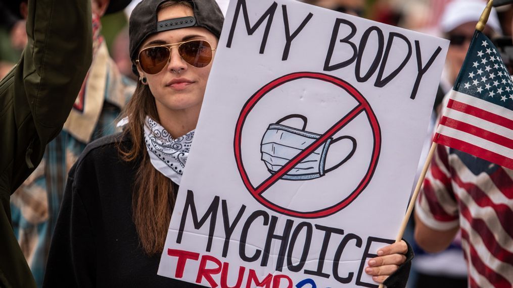 AUSTIN, TX - APRIL 18: A protester holds up a sign protesting wearing a mask at the Texas State Capital building on April 18, 2020 in Austin, Texas. The protest was organized by Infowars host Owen Shroyer who is joining other protesters across the country in taking to the streets to call for the country to be opened up despite the risk of the COVID-19. (Photo by Sergio Flores/Getty Images)