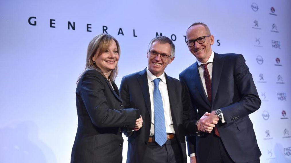 In this March 6, 2017, photo CEO of PSA Carlos Tavares, Opel CEO Karl-Thomas Neumann, right, and GM CEO Mary Barra, left, pose for photographers after addressing the media in Paris, France. On Wednesday, July 5, 2017 the European Union has approved French automaker PSA's acquisition of Opel and British brand Vauxhall from General Motors. The EU's executive Commission said it has given unconditional approval to the deal. (AP Photo/Zacharie Scheurer, file)