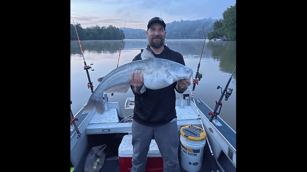 Daughter's eyes covered after fisherman sees what newly caught catfish swallowed. (Screenshot of Richard Kesar's Facebook page)