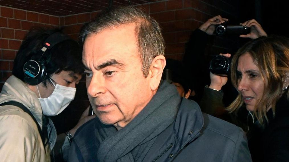 In this April 3, 2019, photo, former Nissan Chairman Carlos Ghosn, center, returns to his residence in Tokyo(Mizuki Ikari/Kyodo News via AP)