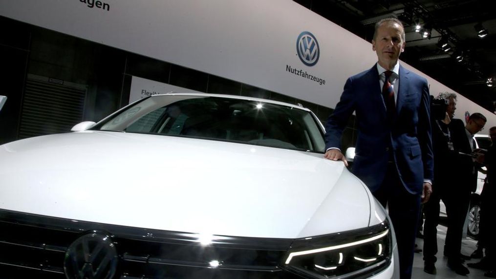 Herbert Diess, CEO of the Volkswagen stock company, poses next to a Volkswagen car prior to the company's annual general meeting in Berlin, Germany, Tuesday, May 14, 2019. (AP Photo/Michael Sohn)