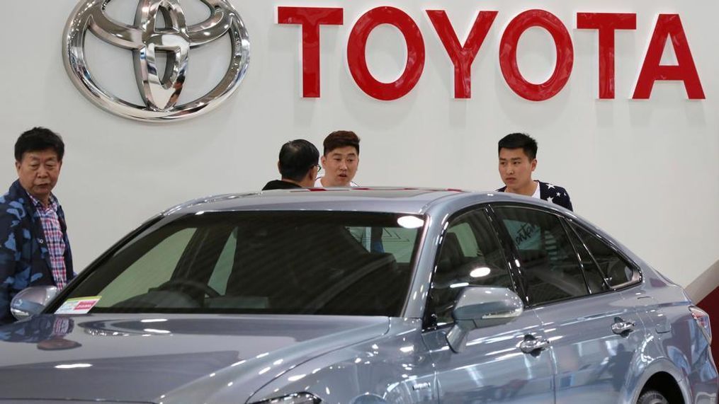 Visitors inspect a Car at Toyota showroom in Tokyo, Wednesday, May 8, 2019. Japan's top automaker Toyota is reporting a 4% dip in profit for January-March after vehicle sales fell in North America. (AP Photo/Koji Sasahara)