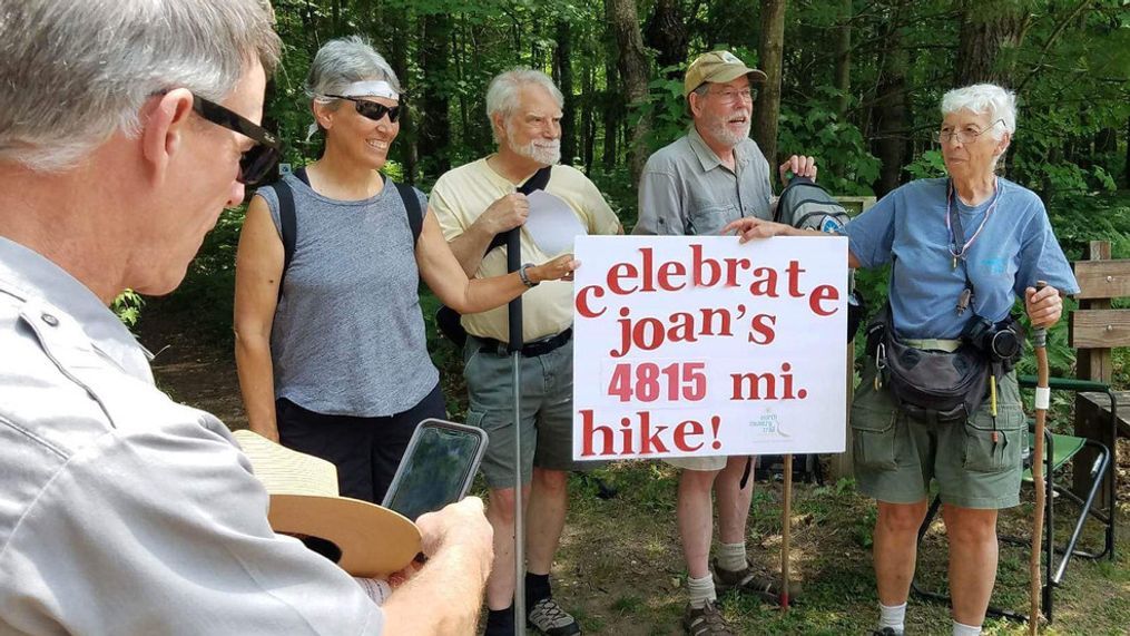 Joan Young, right, is congratulated June 18, 2013, after completing her 4,800-mile hike on the North Country National Scenic Trail.  (Photo taken by Teresa Ann Piatt)